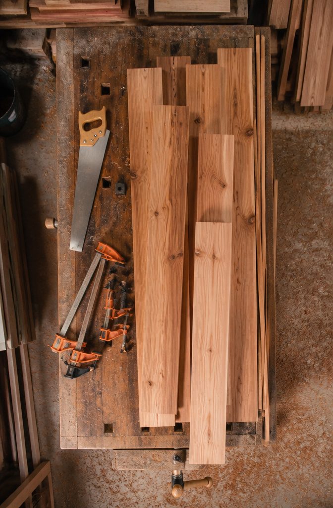 Cedar Wrapped Porch Posts: Styles, Sizes, and Wood Alternatives 8 A cedar board being handled on sawhorses.