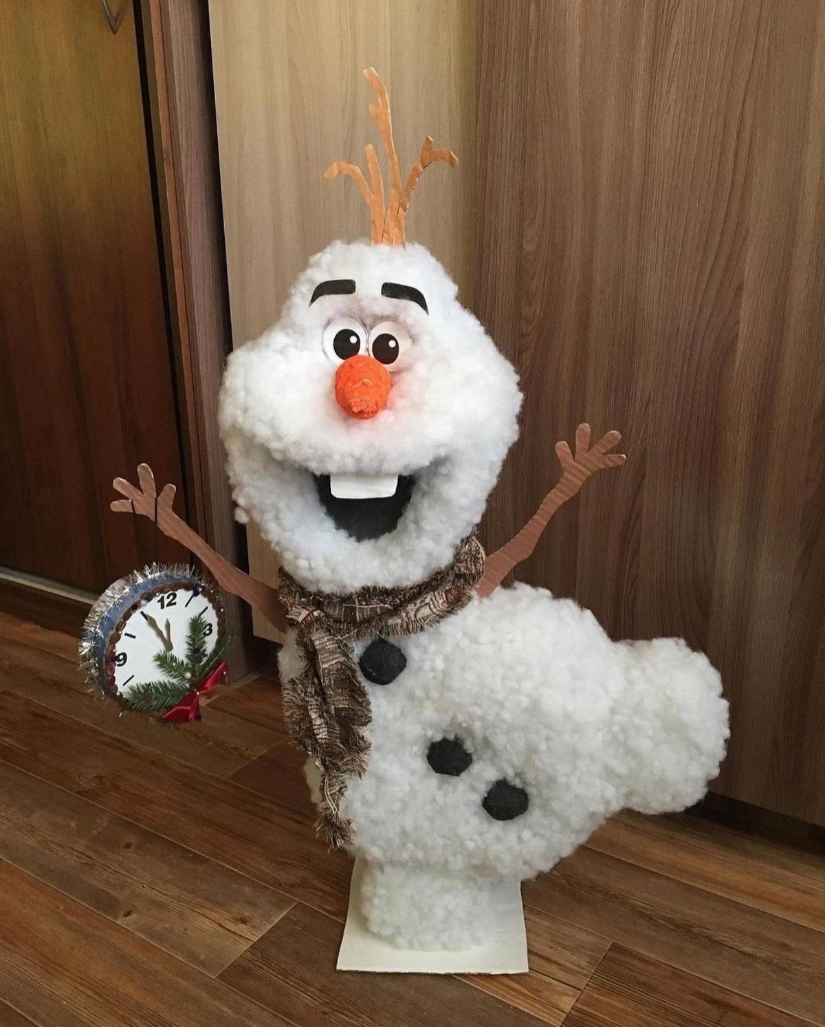 12 Christmas Family Craft Ideas: Projects for All Ages 4 A large, fluffy white cotton snowman decoration with an orange nose and brown scarf.
