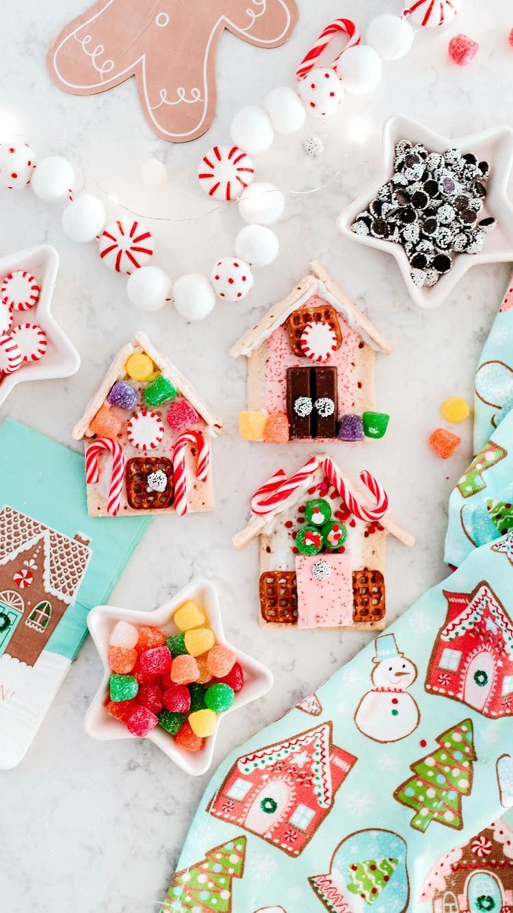 12 Christmas Family Craft Ideas: Projects for All Ages 1 Small decorated gingerbread houses surrounded by colorful candies and peppermint sticks on a white surface.