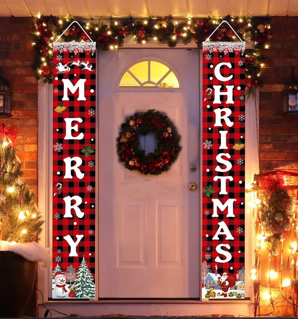 Two red and black plaid banners with Merry Christmas text hanging by a front door.