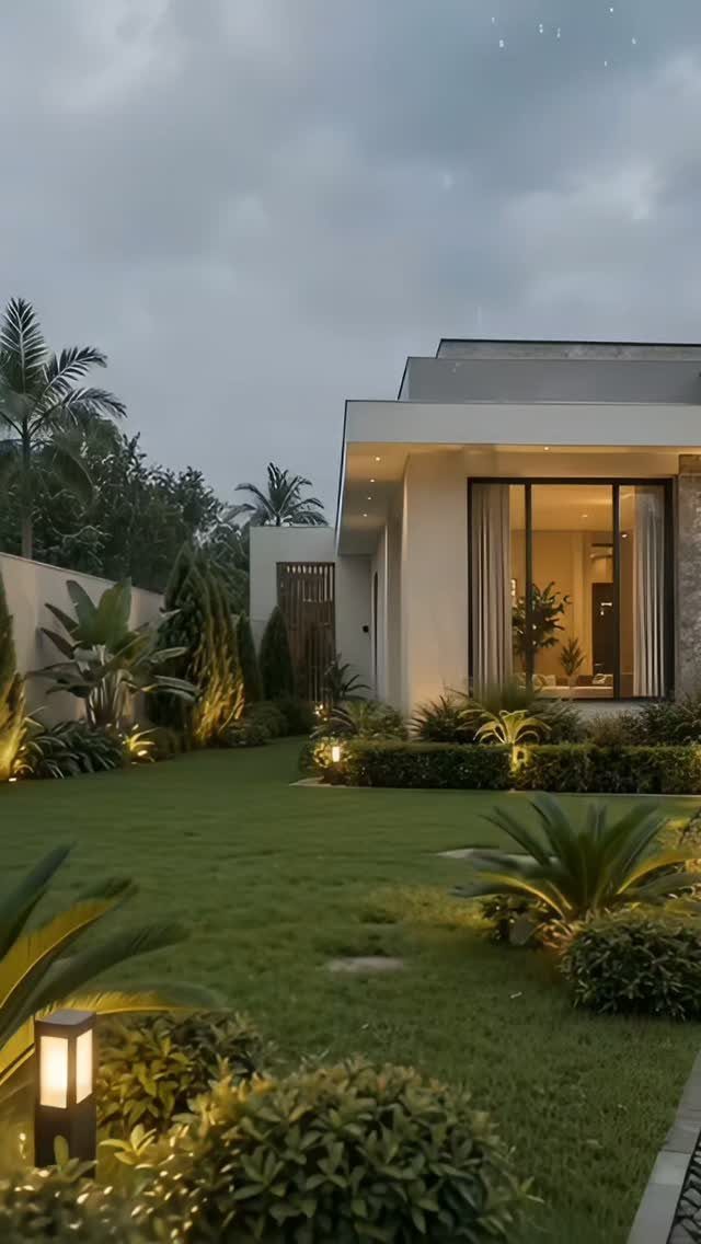 16 Front Lawn Landscaping Ideas for Curb Appeal 5 Small solar lights illuminating tropical plants and a manicured lawn in front of a modern house.