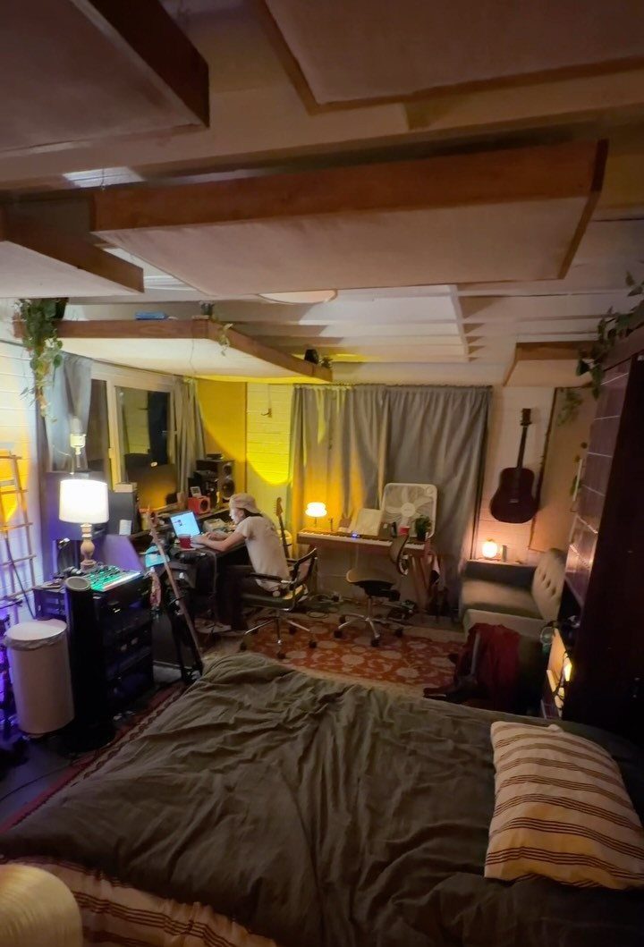 Garage to Bedroom Ideas: 7 Layouts Worth the Conversion Work 4 Acoustic foam panels hanging from the ceiling in a bedroom with a desk and bed.