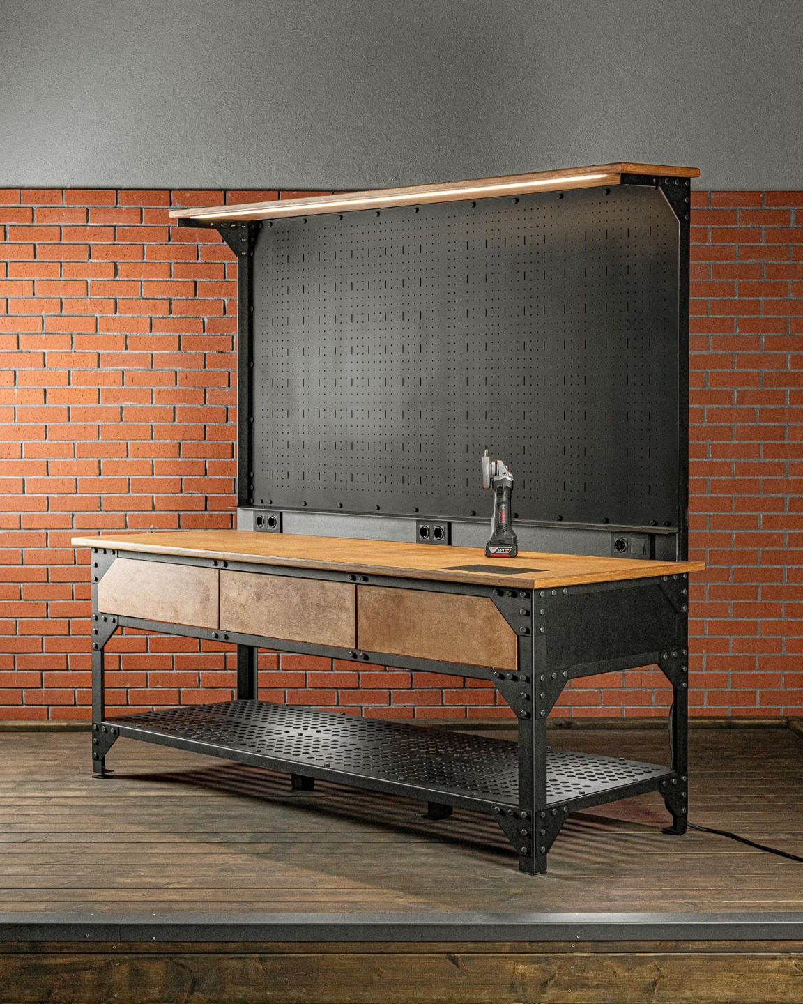 Garage Workbench Ideas: 11 Builds from IKEA Hacks to Heavy-Duty 7 A sturdy black metal workbench with a thick wooden top and pegboard against a brick wall.