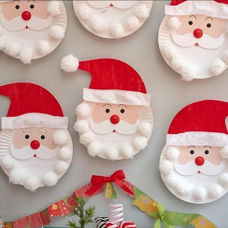 Paper plate Santa Claus faces decorated with red hats and white cotton ball beards.